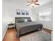Comfortable bedroom with a grey bed, bedside tables with lamps, and a soft area rug at 25 Harbor Oaks Cir, Safety Harbor, FL 34695