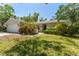 Well landscaped single-story home with a lush green lawn at 25 Harbor Oaks Cir, Safety Harbor, FL 34695