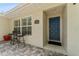 Inviting front porch with a cozy seating area and a blue front door at 25 Harbor Oaks Cir, Safety Harbor, FL 34695
