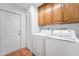 Laundry room with cabinets, closet, washer, and dryer at 25 Harbor Oaks Cir, Safety Harbor, FL 34695