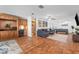 Spacious living room with hardwood floors, ample seating, and access to the outdoor pool area at 25 Harbor Oaks Cir, Safety Harbor, FL 34695