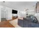Bright living room with modern decor, including a flatscreen TV and comfortable gray sofa at 25 Harbor Oaks Cir, Safety Harbor, FL 34695