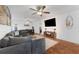 Well-lit living room with a gray sectional, modern decor, and an open layout perfect for entertaining at 25 Harbor Oaks Cir, Safety Harbor, FL 34695
