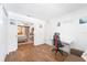 Office space with wood floors, desk, and doorway to bedroom at 25 Harbor Oaks Cir, Safety Harbor, FL 34695