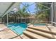 Enclosed pool with spa and seating area at 25 Harbor Oaks Cir, Safety Harbor, FL 34695