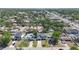 This aerial view shows well-maintained homes, green lawns, mature trees, and convenient access to roads and nearby amenities at 3612 W Pearl Ave, Tampa, FL 33611