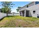 Spacious backyard with a screened patio and full fence at 3612 W Pearl Ave, Tampa, FL 33611