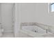 Bathroom features a jacuzzi tub with marble tile surround at 3612 W Pearl Ave, Tampa, FL 33611