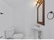 Clean half bathroom with white toilet and pedestal sink at 3612 W Pearl Ave, Tampa, FL 33611