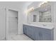 Bathroom features a double vanity, tile flooring, and walk-in closet at 3612 W Pearl Ave, Tampa, FL 33611