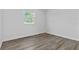 Upstairs bedroom features hardwood floors, natural light, and neutral paint at 3612 W Pearl Ave, Tampa, FL 33611