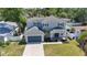 A beautiful two-story home boasts a spacious garage and well-manicured lawn and lush landscaping at 3612 W Pearl Ave, Tampa, FL 33611