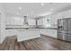 Spacious kitchen featuring white cabinets, stainless steel appliances, granite countertops and large island at 3612 W Pearl Ave, Tampa, FL 33611