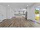 Bright open-concept kitchen with granite counters, stainless appliances and hardwood floors at 3612 W Pearl Ave, Tampa, FL 33611