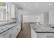 Bright kitchen features granite countertops, stainless steel appliances, and wood flooring at 3612 W Pearl Ave, Tampa, FL 33611