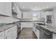 Beautiful kitchen featuring white cabinetry, granite counters and stainless steel appliances at 3612 W Pearl Ave, Tampa, FL 33611