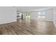 Open-concept living room with wood-look floors and ample natural light at 3612 W Pearl Ave, Tampa, FL 33611