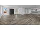 Open-concept living room with neutral paint and wood-look floors at 3612 W Pearl Ave, Tampa, FL 33611