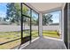 Cozy screened patio with wood flooring and a view of the fenced backyard at 3612 W Pearl Ave, Tampa, FL 33611