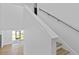 Open staircase with wood treads, white risers and stainless handrail at 3612 W Pearl Ave, Tampa, FL 33611