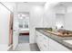 Bathroom showcasing a granite-topped vanity and modern shower stall with view into bedroom at 36454 Flats St, Zephyrhills, FL 33541
