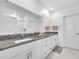 Bathroom featuring dual sinks, granite countertops, and a bright, clean aesthetic at 36454 Flats St, Zephyrhills, FL 33541