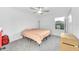 Simple bedroom with a ceiling fan and a large window providing ample natural light at 36454 Flats St, Zephyrhills, FL 33541