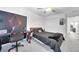 Cozy bedroom featuring a bed with black linens, a gaming setup, and neutral-toned walls at 36454 Flats St, Zephyrhills, FL 33541