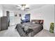 Bright bedroom featuring a ceiling fan, carpet flooring, and a desk area, illuminated by natural light at 36454 Flats St, Zephyrhills, FL 33541