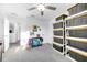 Bright bedroom featuring a ceiling fan and storage shelving at 36454 Flats St, Zephyrhills, FL 33541