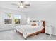 Bright bedroom with carpet and ceiling fan, white linens, and natural light from windows at 36454 Flats St, Zephyrhills, FL 33541