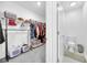Walk-in closet and small bathroom feature a wire shelving system and a toilet with neutral decor at 36454 Flats St, Zephyrhills, FL 33541
