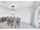 A well-lit dining area features modern chandelier and a gray cabinet with a marble countertop at 36454 Flats St, Zephyrhills, FL 33541