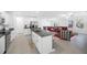 Modern kitchen flows into the living room, with stainless steel appliances and granite countertops at 36454 Flats St, Zephyrhills, FL 33541