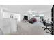 Open loft area with neutral paint and carpet, a ceiling fan and great natural light at 36454 Flats St, Zephyrhills, FL 33541