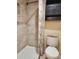 Tiled shower, and black cabinet complement this simple bathroom space at 379 47Th N Ave # 104, St Petersburg, FL 33703