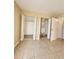 Spacious bedroom offers ample storage with walk-in closets and neutral tile flooring at 379 47Th N Ave # 104, St Petersburg, FL 33703