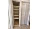 Organized closet with multiple shelves and white louvered doors at 379 47Th N Ave # 104, St Petersburg, FL 33703