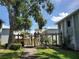 Inviting community featuring trellises and mature trees against building and blue sky at 379 47Th N Ave # 104, St Petersburg, FL 33703
