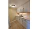 Well-lit kitchen area showcasing modern sink, cabinets, and neutral walls at 379 47Th N Ave # 104, St Petersburg, FL 33703