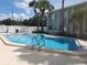 Sparkling community pool surrounded by palm trees and well-maintained building exterior at 379 47Th N Ave # 104, St Petersburg, FL 33703