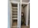 Utility closet showing shelves and water heater, enhancing home practicality at 379 47Th N Ave # 104, St Petersburg, FL 33703