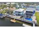 Aerial view of a waterfront property with a dock, boat lifts, swimming pool, outdoor bar, and lush landscaping at 4039 Casa Ct, Hernando Beach, FL 34607