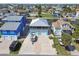 Aerial view of a waterfront neighborhood, highlighting a home with a two-car garage and boat on trailer in the driveway at 4039 Casa Ct, Hernando Beach, FL 34607