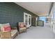 Relaxing balcony with wicker chairs, throw pillows, stainless steel refrigerator, and scenic views at 4039 Casa Ct, Hernando Beach, FL 34607