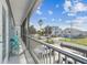 Balcony showcasing views of the neighborhood, across the street, with palm trees and other coastal homes at 4039 Casa Ct, Hernando Beach, FL 34607
