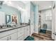 Bright bathroom with double vanity, granite counters, a tub, shower, and wood look flooring at 4039 Casa Ct, Hernando Beach, FL 34607