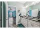 Bathroom features double sink vanity, granite countertop, and wood floors at 4039 Casa Ct, Hernando Beach, FL 34607