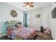 Cozy bedroom featuring a comfortable bed, a colorful bedspread, and a ceiling fan at 4039 Casa Ct, Hernando Beach, FL 34607