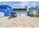 Charming waterfront home with boat, brick driveway, two-car garage, and second story porch at 4039 Casa Ct, Hernando Beach, FL 34607